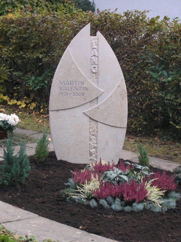 Weißer Ovalgrabstein mit Reliefformen